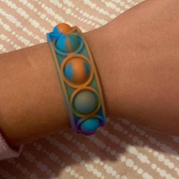 Three pop it bracelets. Good pops. One yellow one rainbow and one multi colored - Picture 4 of 4